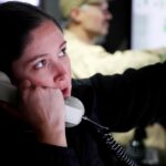 Sailors operating helm in Virginia-class submarine control room