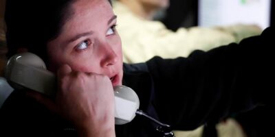 Sailors operating helm in Virginia-class submarine control room